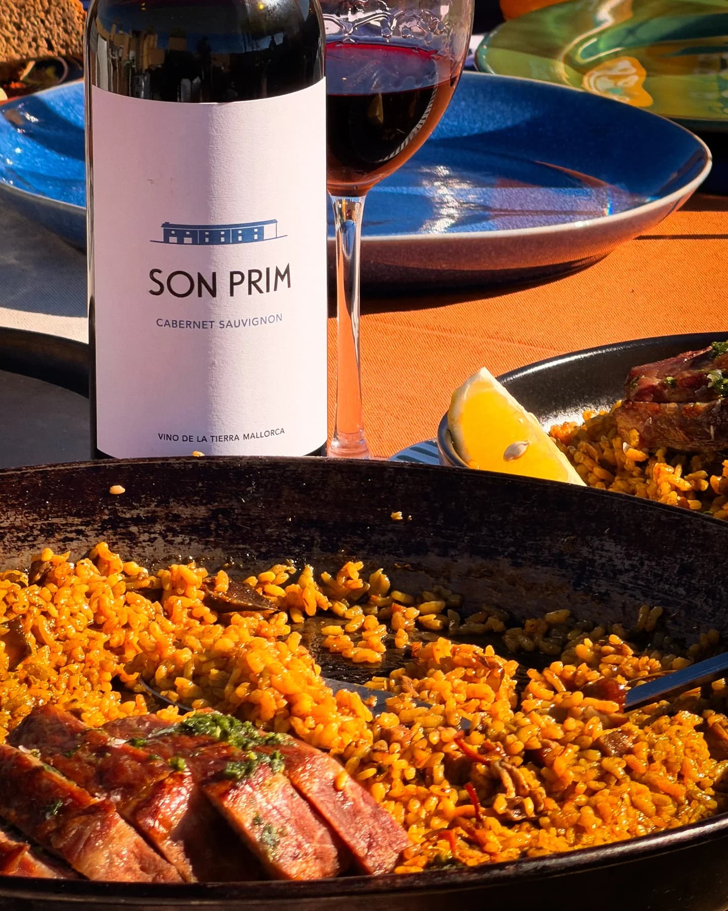 Paella with Iberian presa served at a private dining table in Mallorca